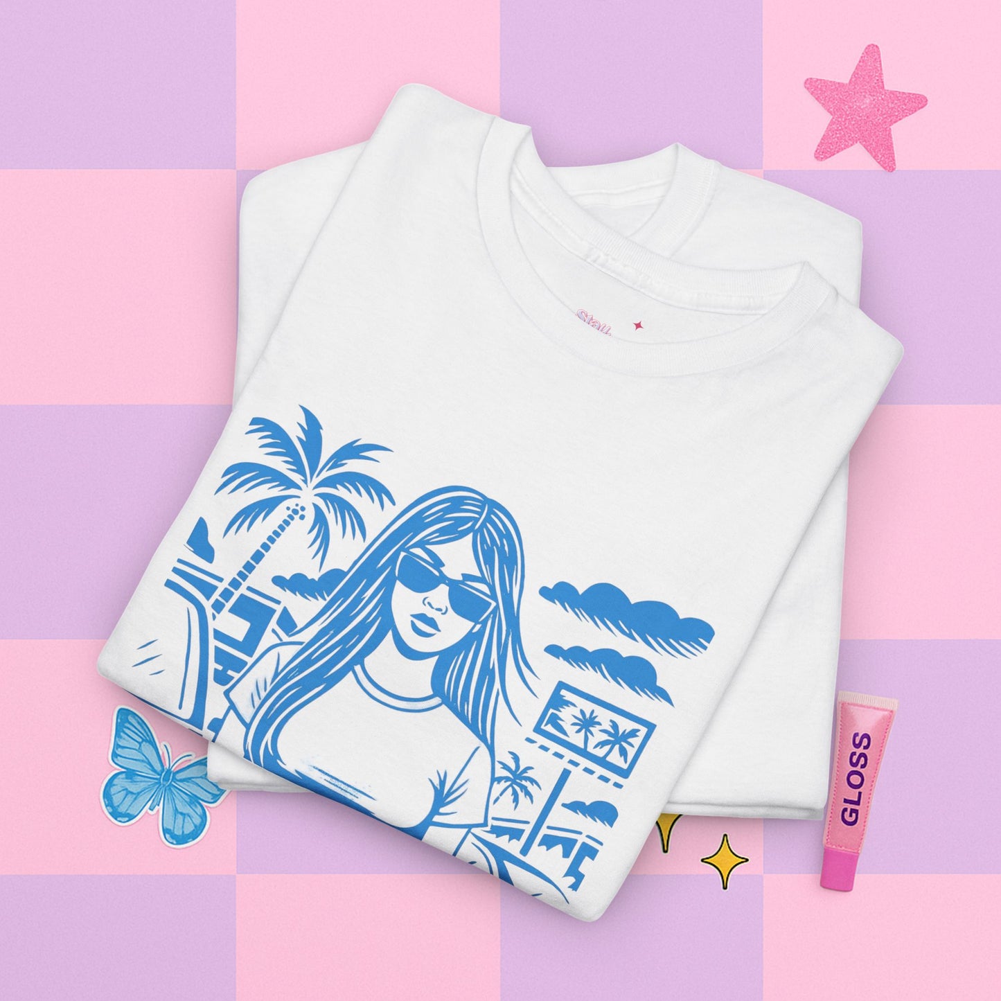 White t-shirt with blue graphic design on a pastel checkered background