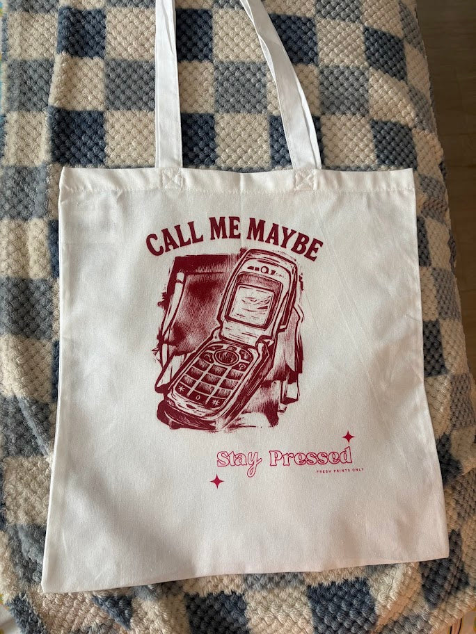Tote bag with 'Call Me Maybe' design on a checkered fabric background
