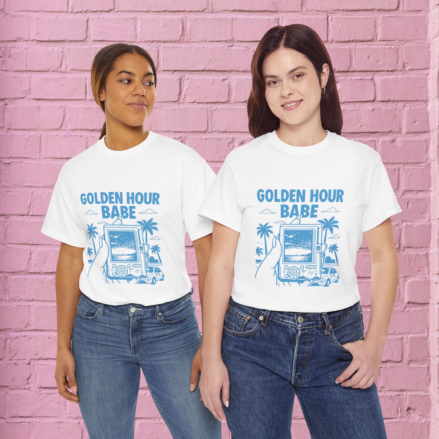 Two people wearing 'Golden Hour Babe' t-shirts against a pink brick wall.