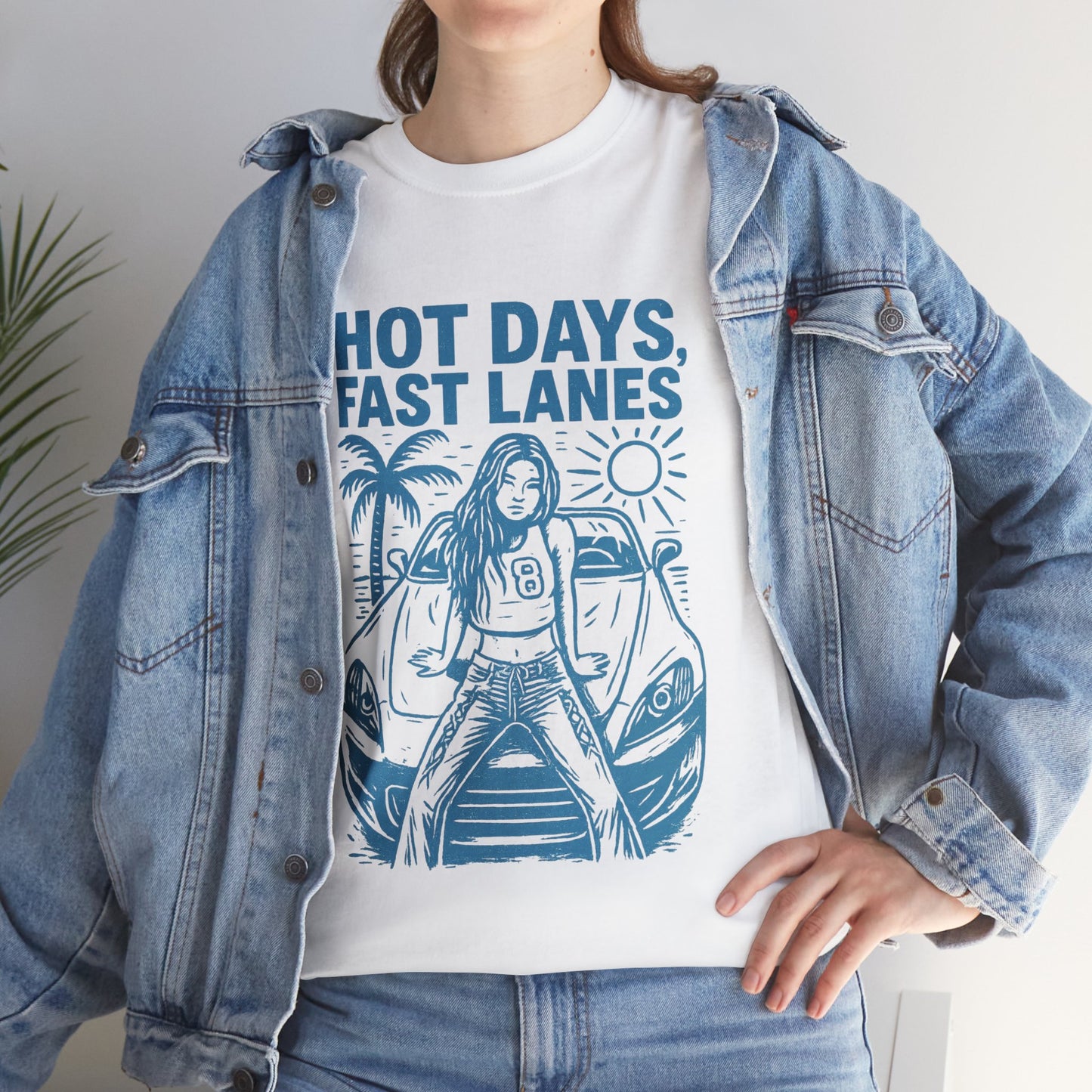 Person wearing a white t-shirt with blue graphic design and denim jacket.