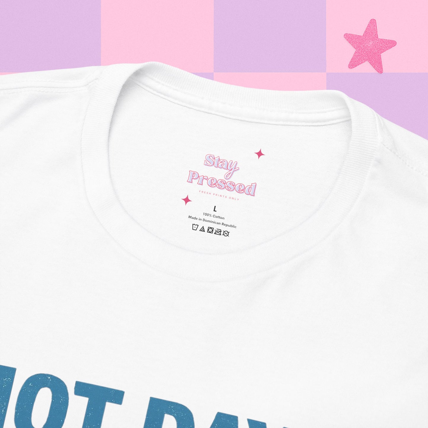 White t-shirt with pink text on a checkered background close up shot our logo and how the label will look