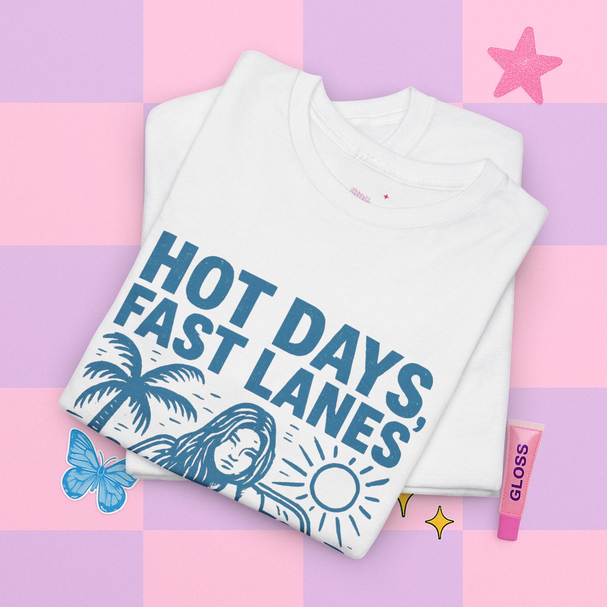 Folded white t-shirt with 'Hot Days, Fast Lanes' text on a colorful background