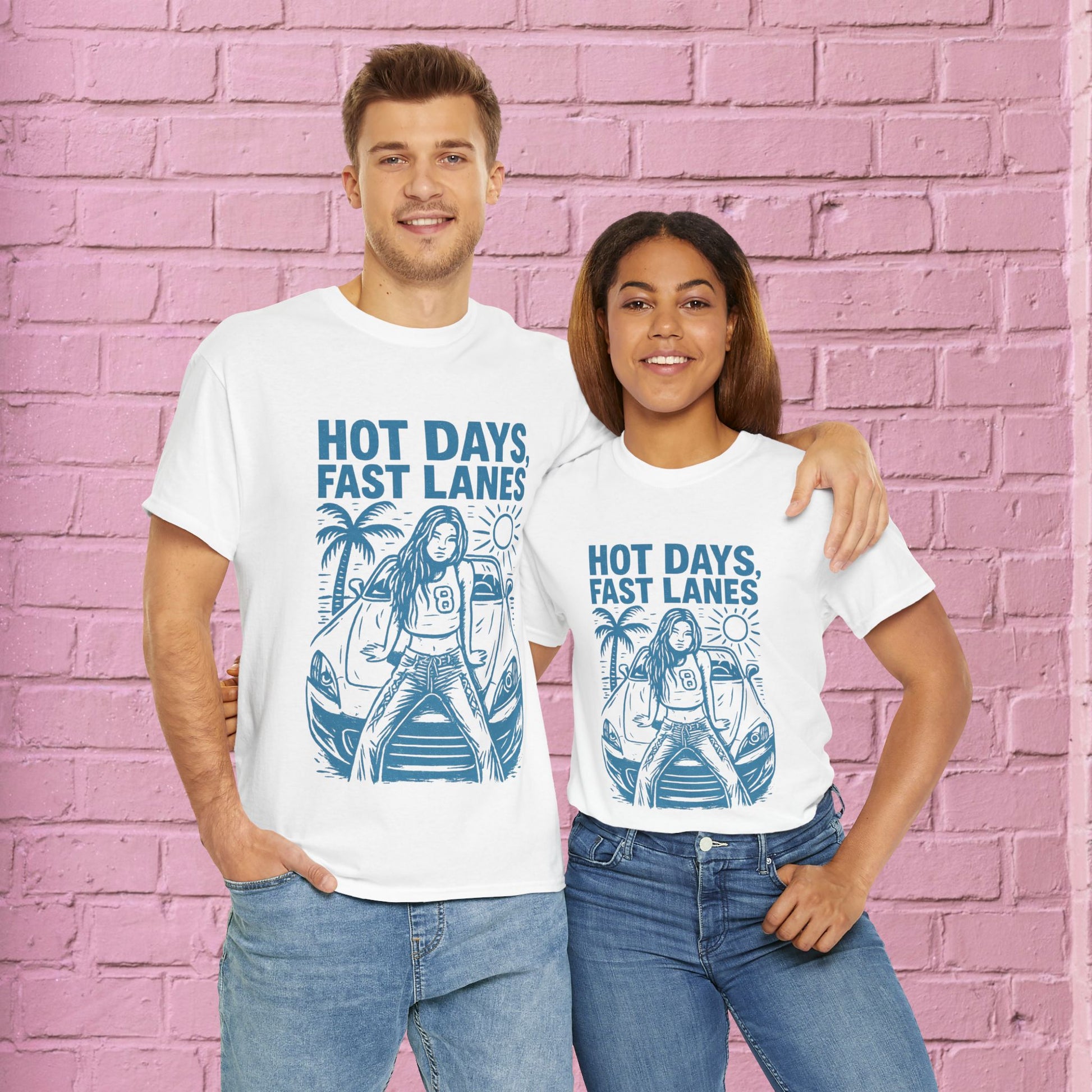 Two people wearing white t-shirts with a graphic design and text against a pink brick wall.